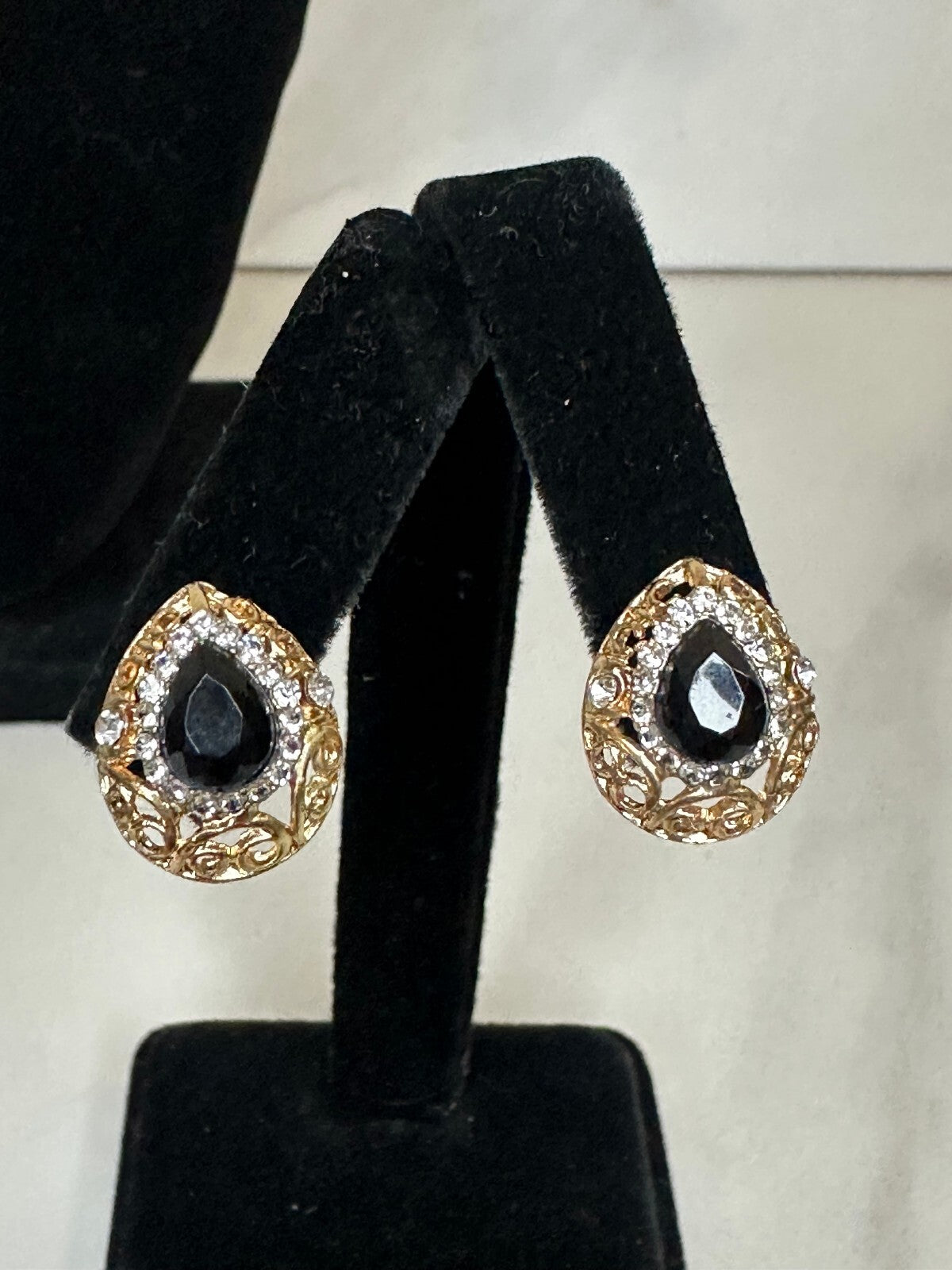 Matching gold-tone black and crystal teardrop earrings and pendant set
