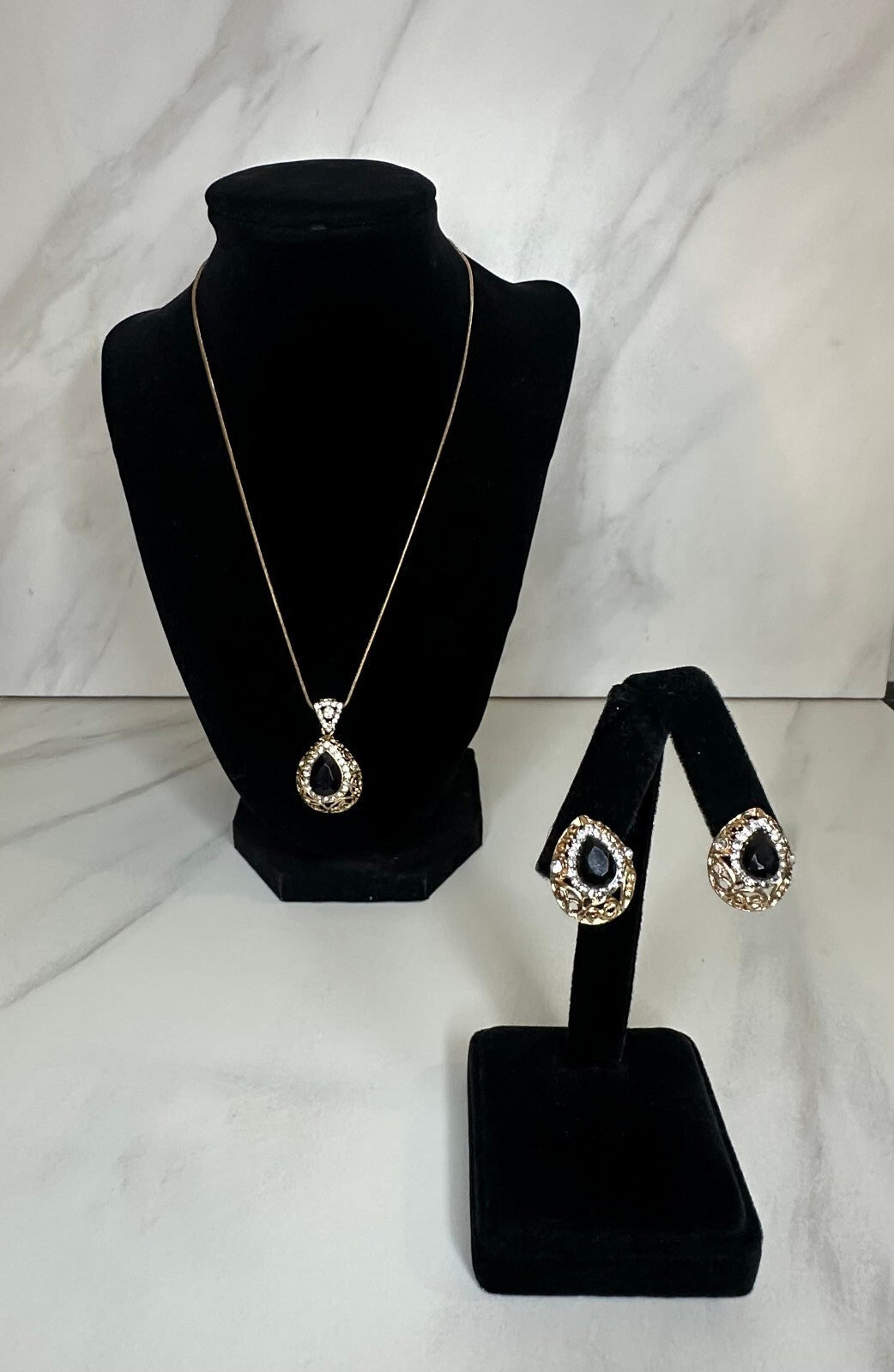 Matching gold-tone black and crystal teardrop earrings and pendant set