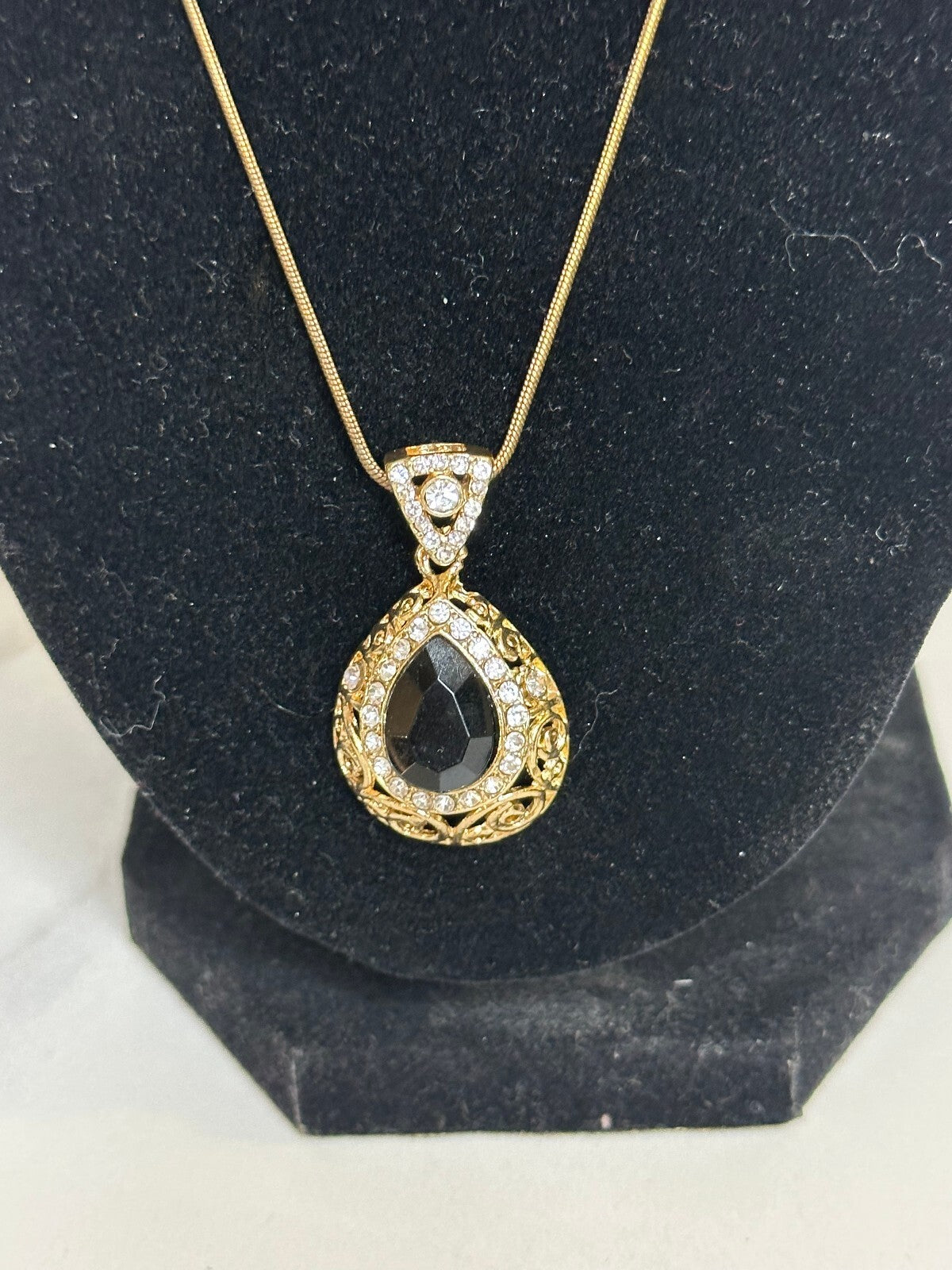 Matching gold-tone black and crystal teardrop earrings and pendant set